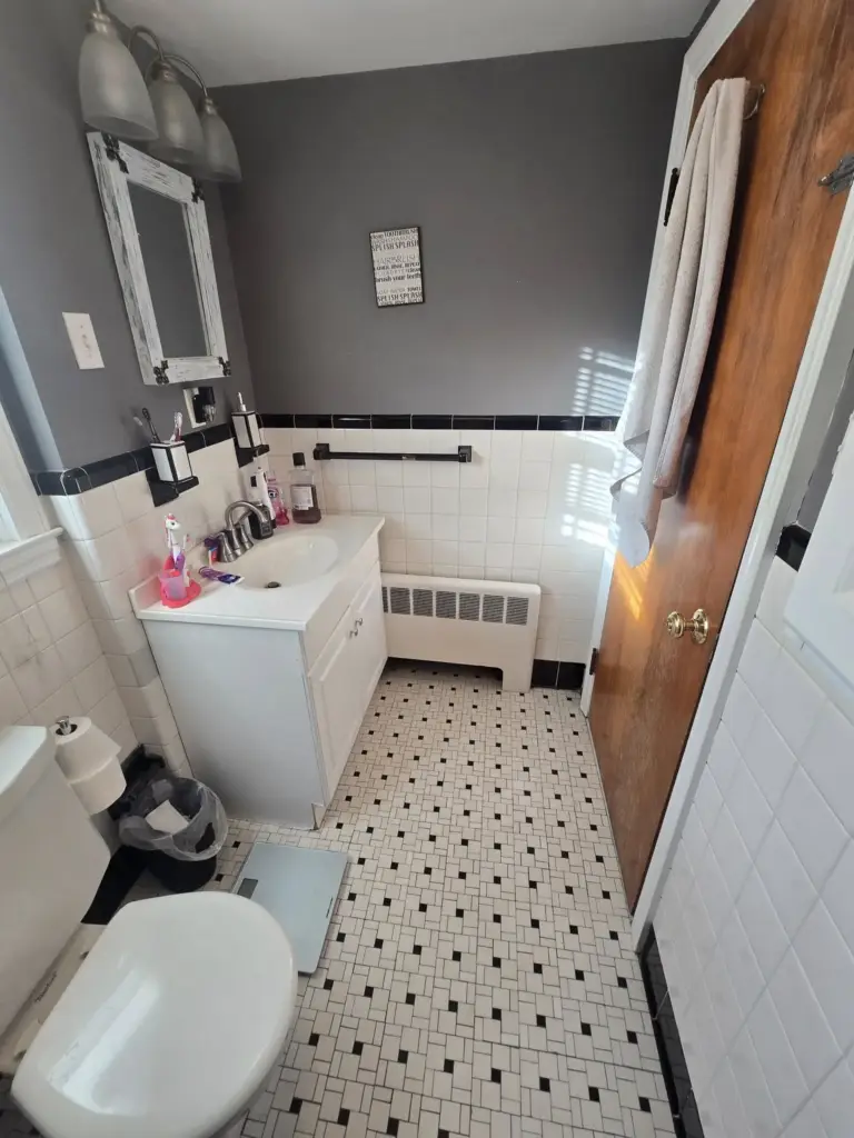Bristol CT bathroom before remodeling, with dated black-and-white tile and a small vanity