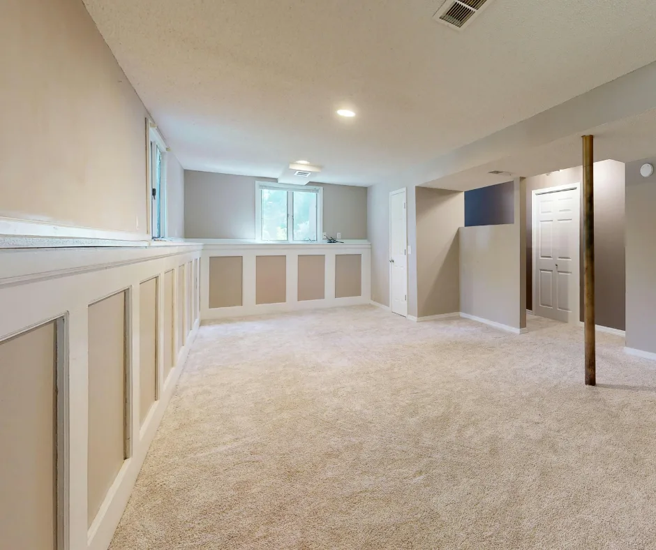 Finished basement with new carpet, wainscoting, and recessed lighting