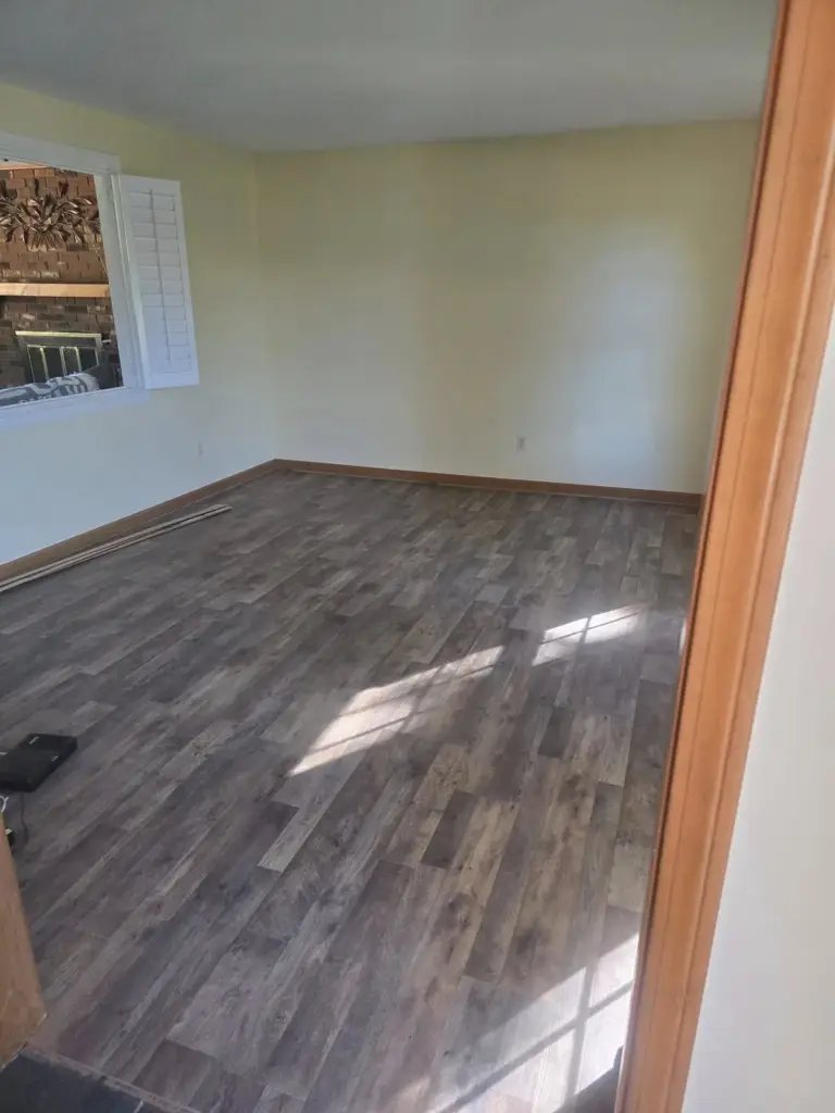 New wood-look flooring installed in a refreshed living room