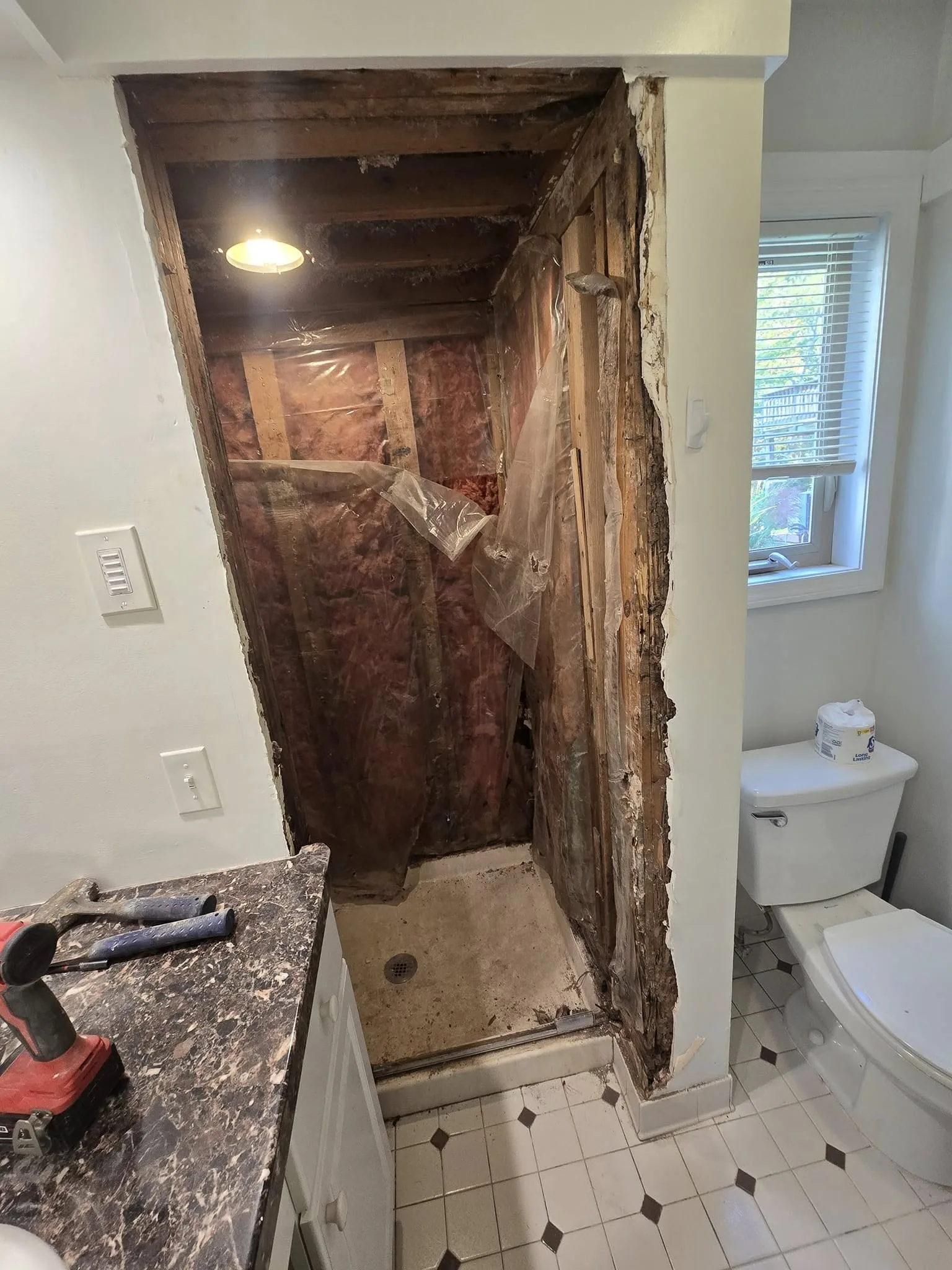 Simsbury CT bathroom during demolition with shower walls removed to the studs