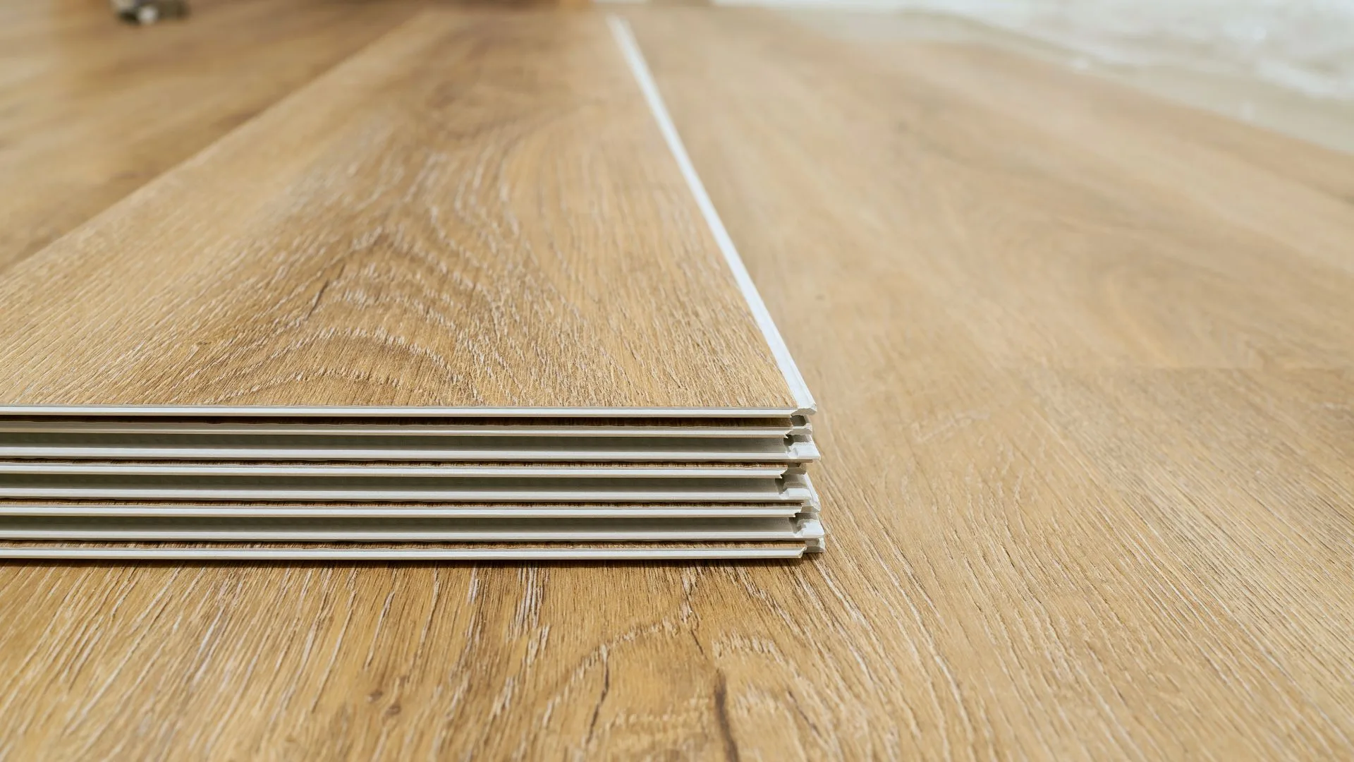 Stacked luxury vinyl plank flooring ready for installation
