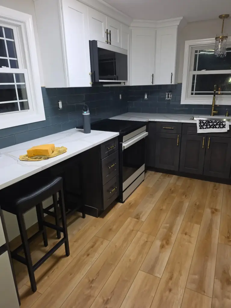 New range, over-the-range microwave, and glass subway tile backsplash in a Bristol CT kitchen remodel