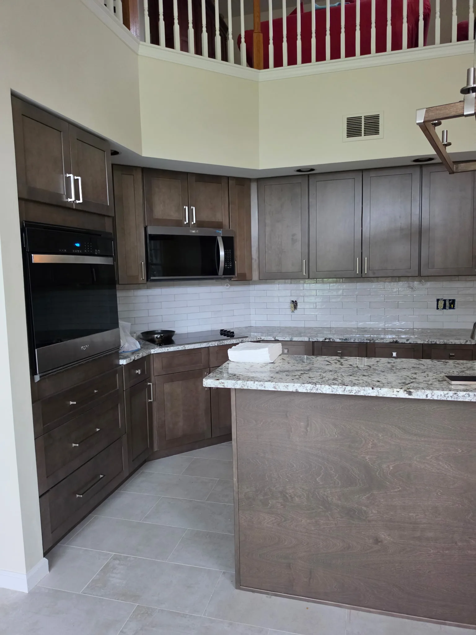 Remodeled Cromwell CT condo kitchen with gray shaker cabinets, granite counters, and subway tile backsplash