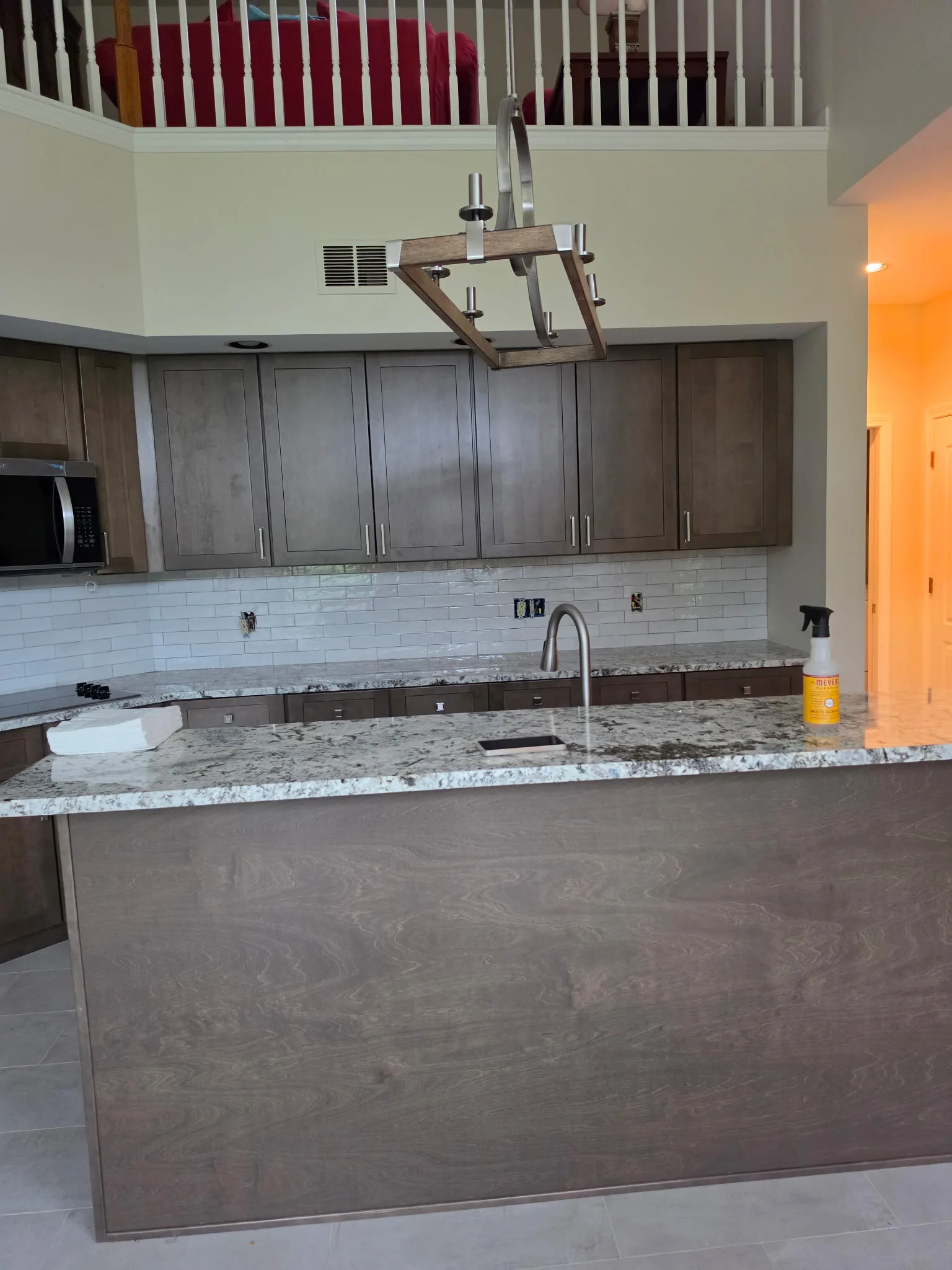 New kitchen island with granite countertop and pendant lighting in a Cromwell CT condo remodel