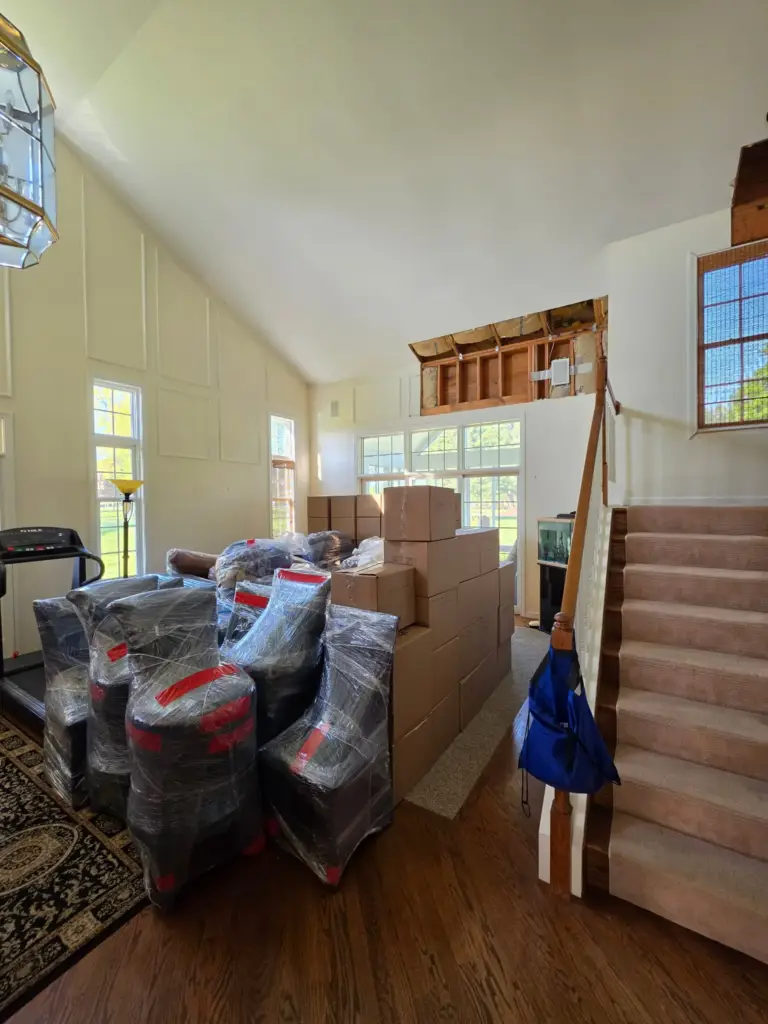 Cromwell CT condo living room packed up with water-damaged drywall removed to the studs