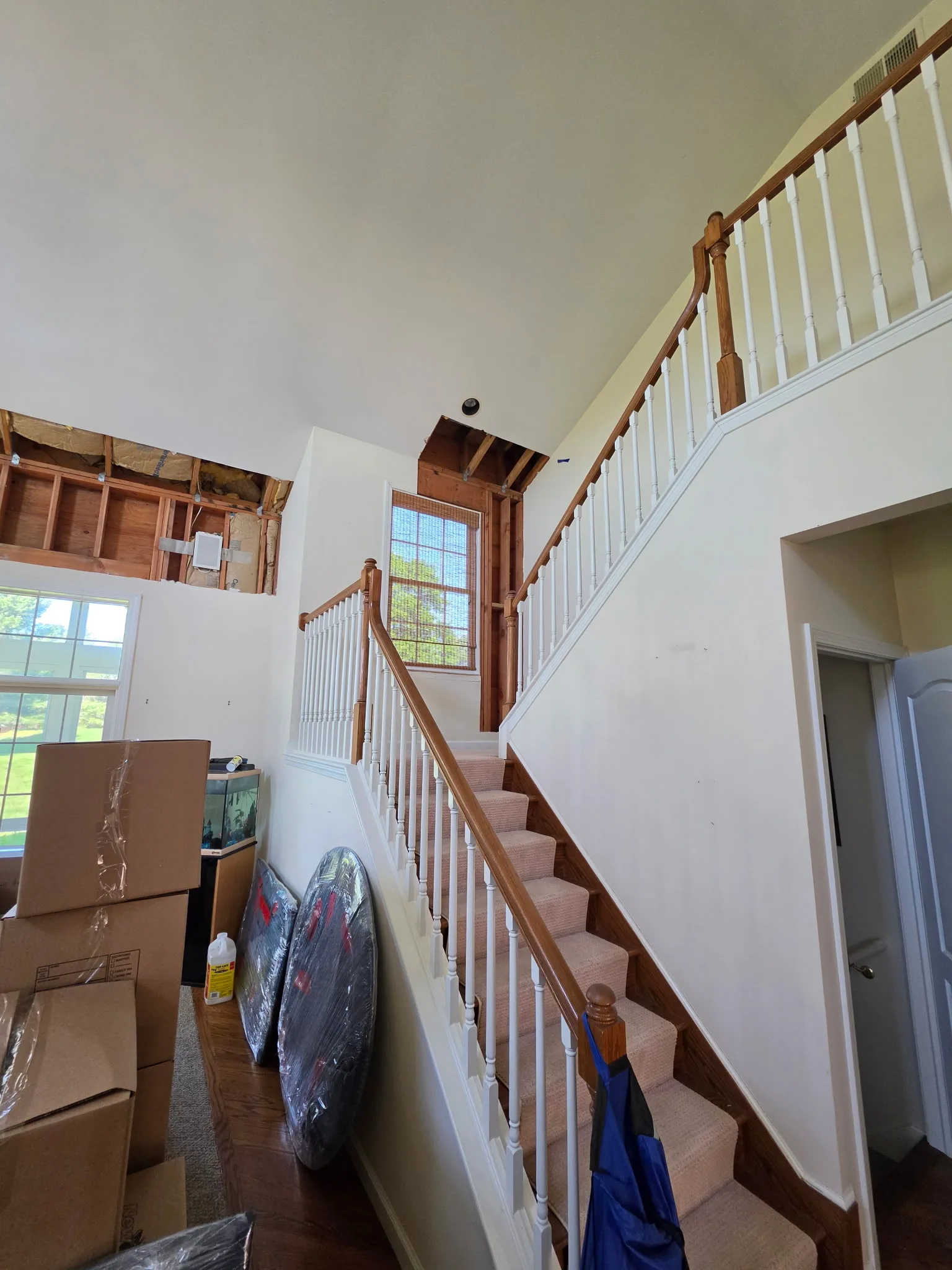 Stairway wall opened to the studs after water damage remediation in a Cromwell CT condo