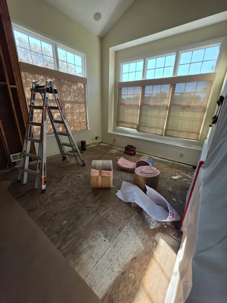 Exposed subfloor and opened wall during the water damage rebuild in a Cromwell CT condo
