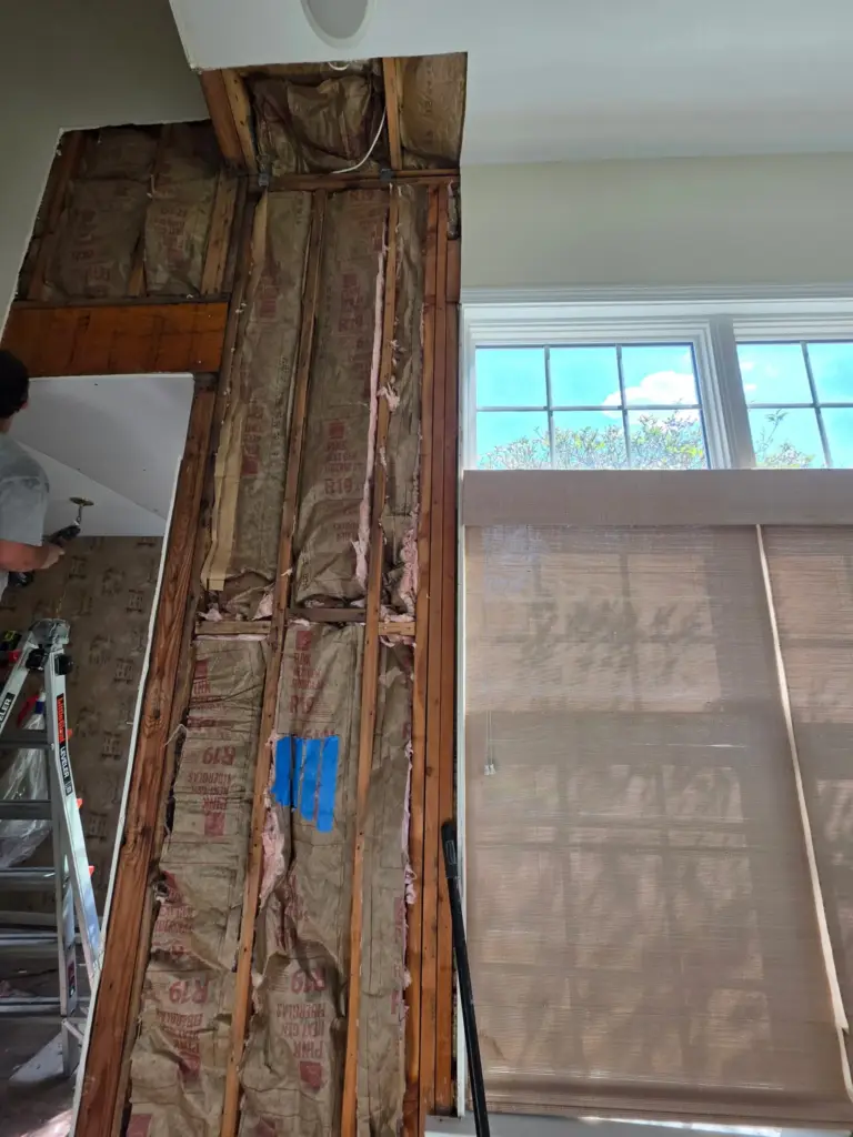 Myers crew hanging new drywall on a wall opened to the studs in a Cromwell CT condo