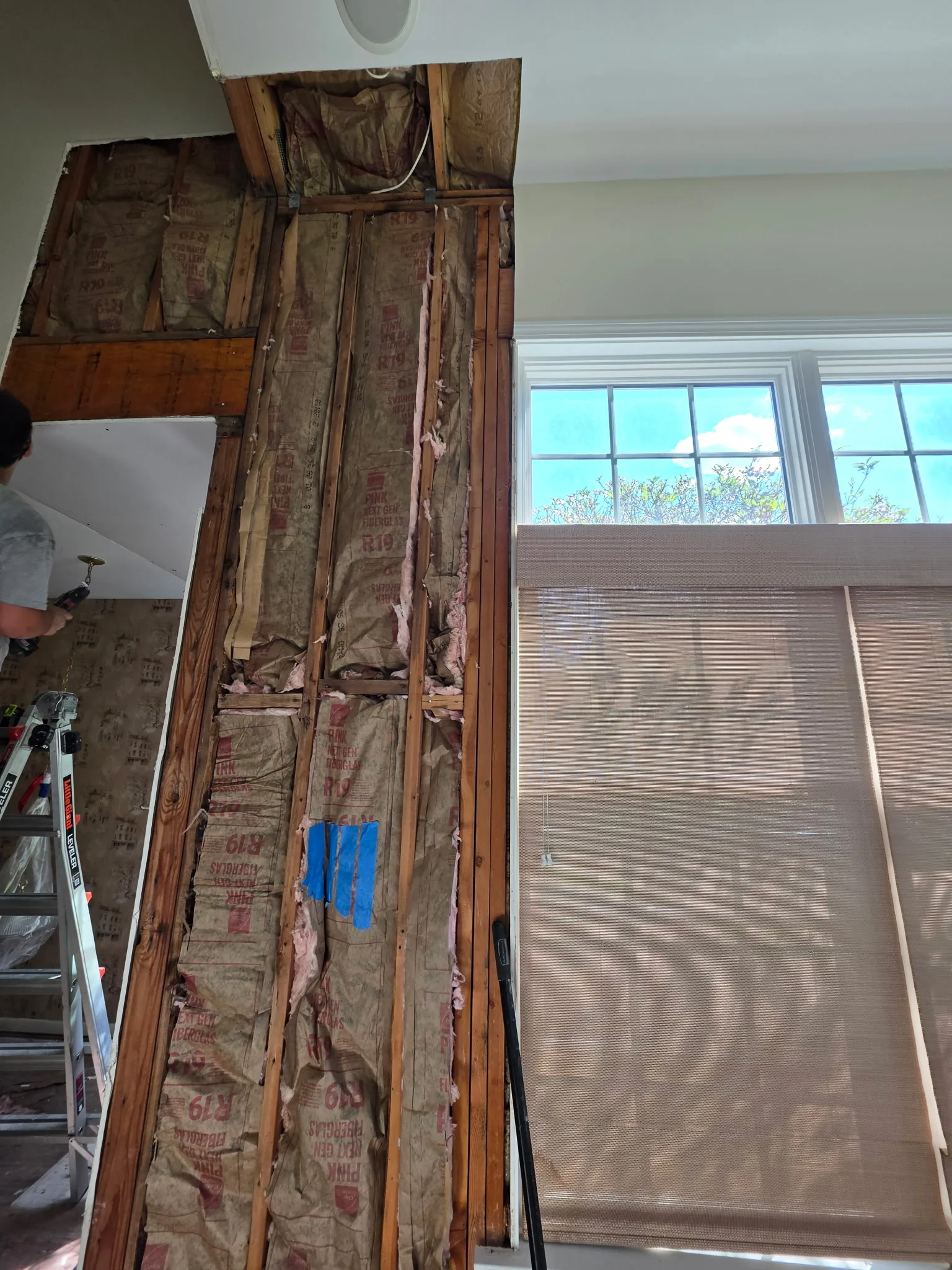 Myers crew hanging new drywall on a wall opened to the studs in a Cromwell CT condo