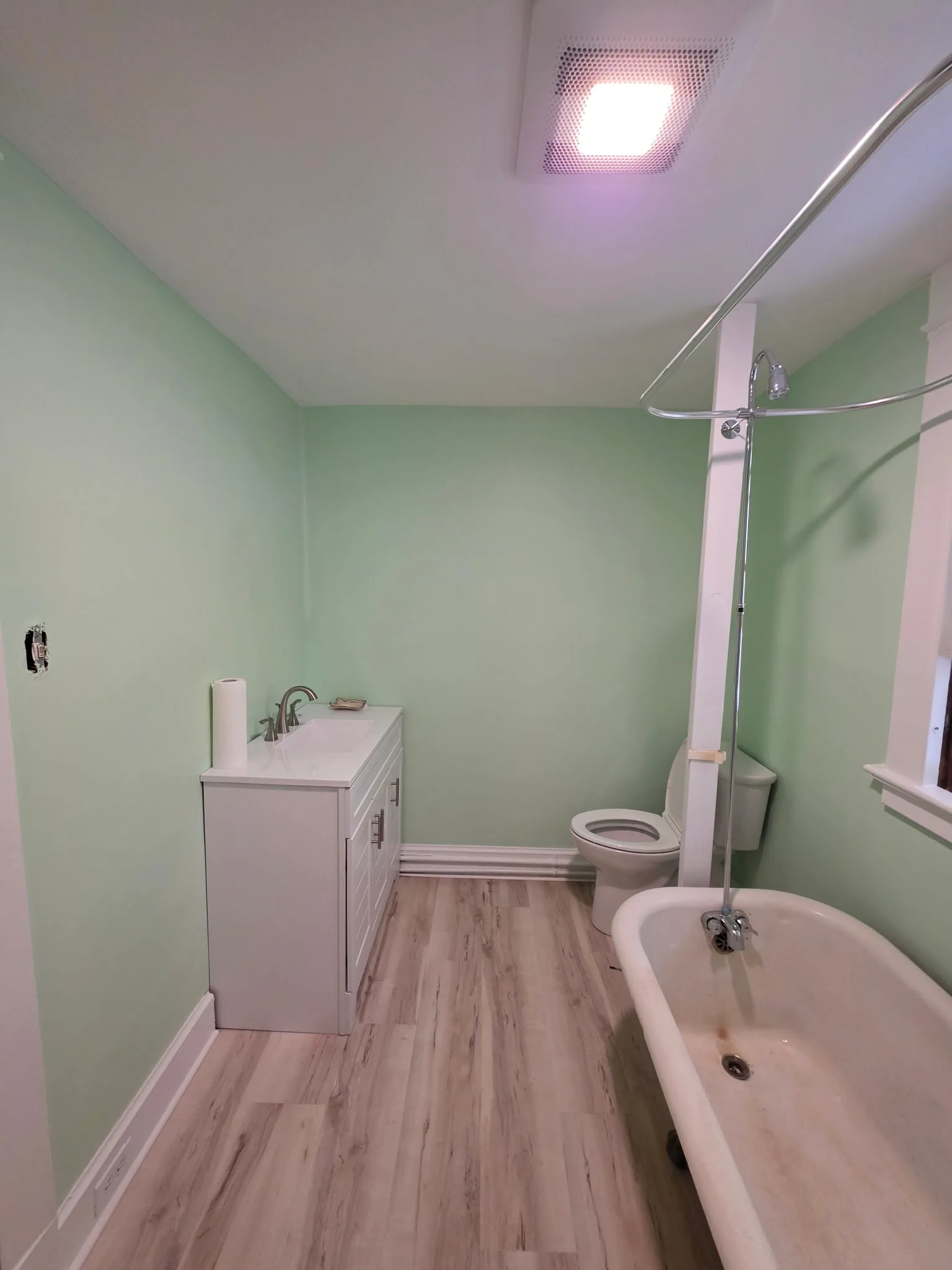 Remodeled Torrington CT bathroom with new vanity, new toilet, LVP flooring, and fresh paint
